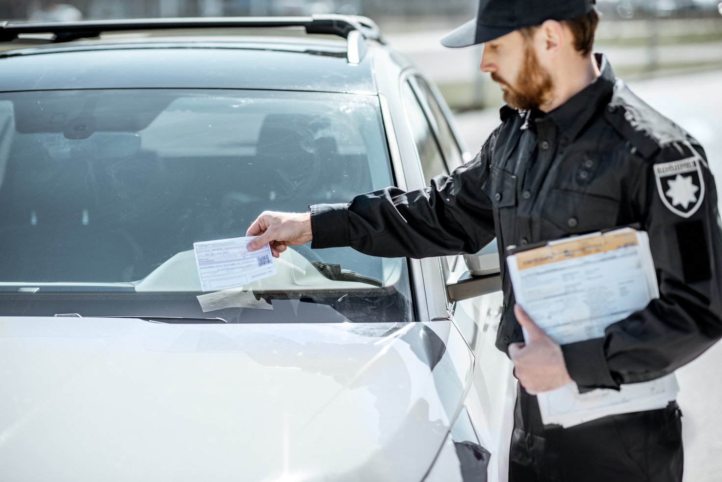 Policeman Putting Fine on the Car