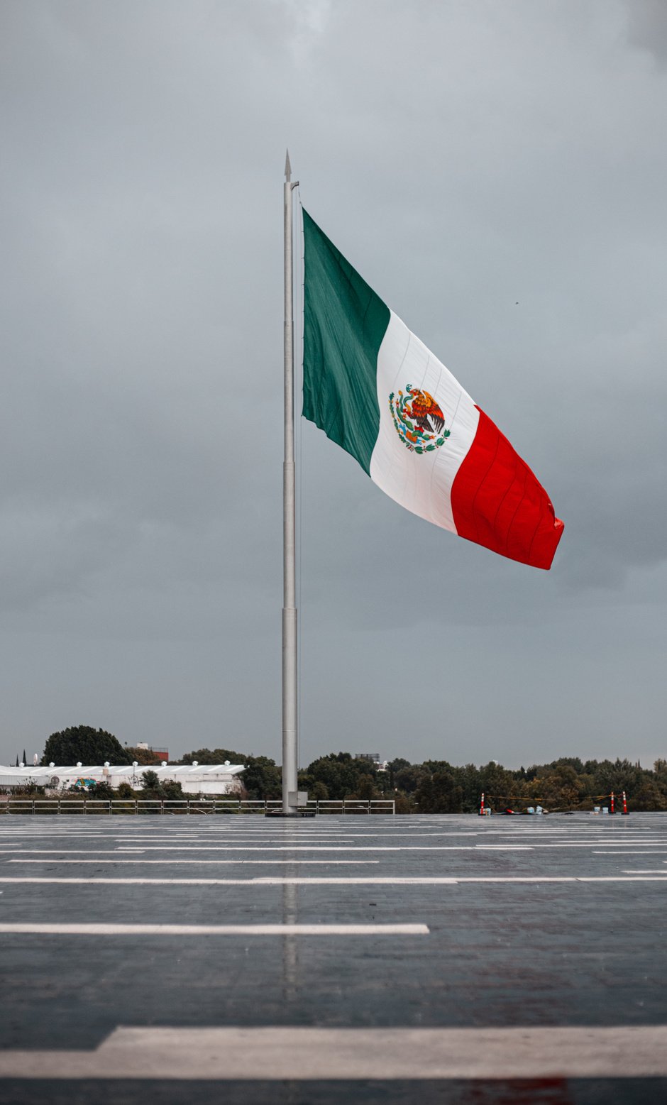 monumental mexican flag waving on a rainy day in puebla